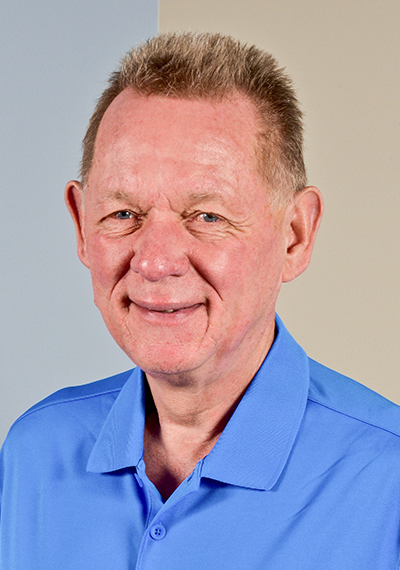 headshot of ACS employee Chuck Meritts in sky blue shirt