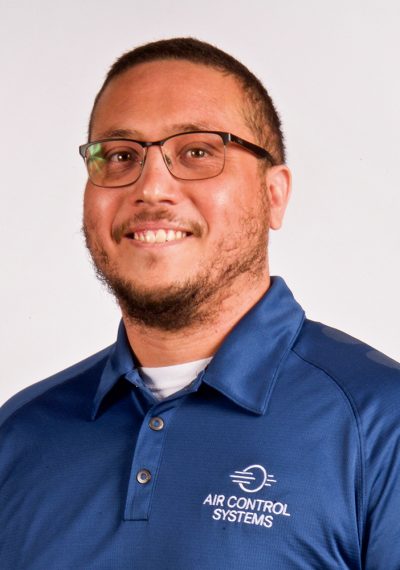 Headshot of Keith Bacosa in blue ACS shirt against white backdrop